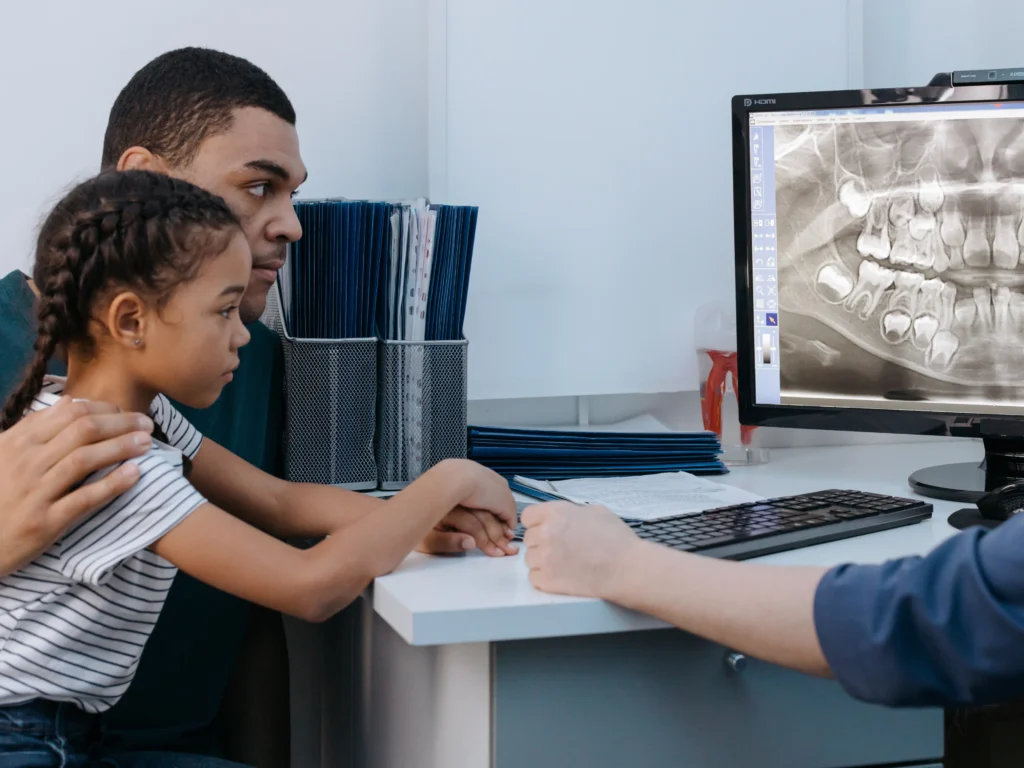 Father and daughter looking at their dental xray